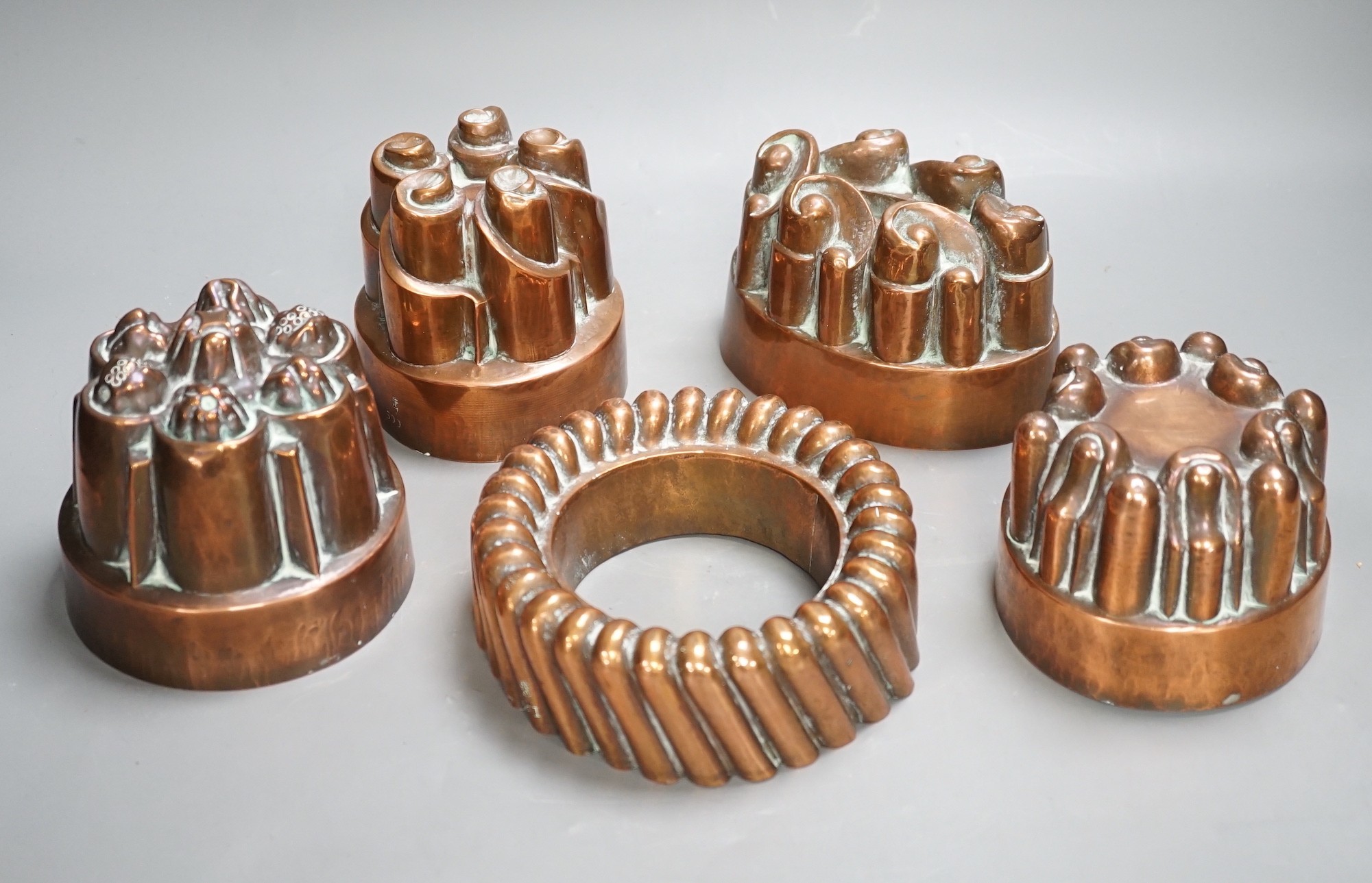 Five Victorian Benham & Froud copper jelly moulds, tallest 12cms